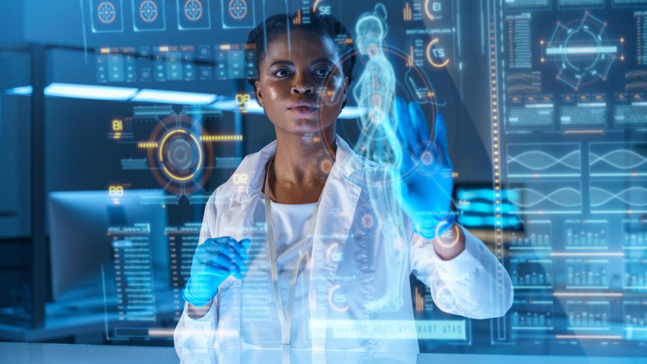 Researcher interacting with digital data interface to analyze human performance metrics.